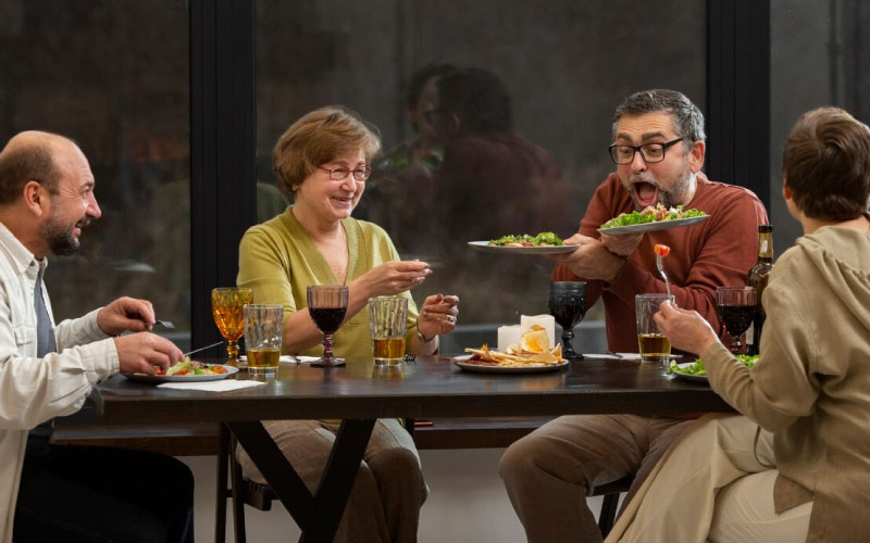 friends eating at a colourful, long dining table, food scene, August 2024, Australia