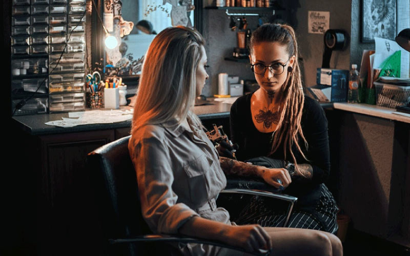 woman getting a tattoo, unique Brisbane souvenir, October 2024, Australia