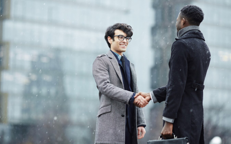 Business people shaking hands, corporate travel, January 2025, Australia