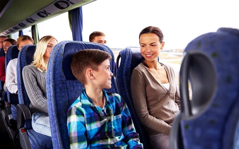 a family in coach watching the open road, travel tip